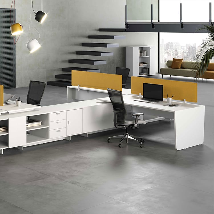 Modern office space featuring the Metrik Workstation Collection. White desks with yellow dividers, ergonomic chairs, and storage.