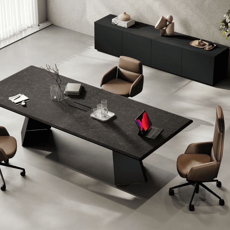 Modern Monolith Executive Desk. Dark stone top, metal base, brown leather chairs, and sleek black storage.