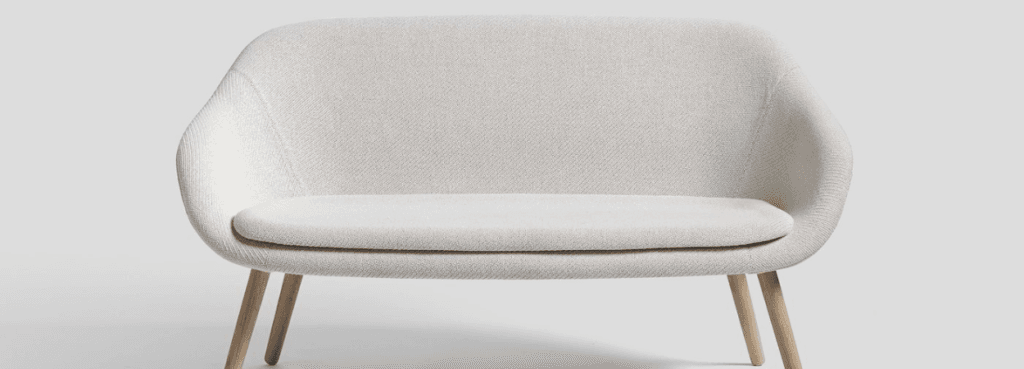 Minimalist white AAL Sofa by HAY with wooden legs. Social & Relaxed Spaces.