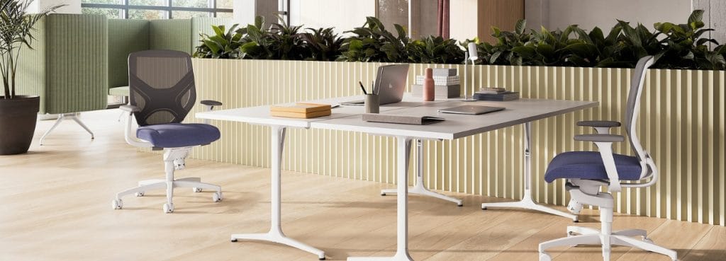 Modern office space featuring Wilkhahn IN chair in blue and white with active sitting design.