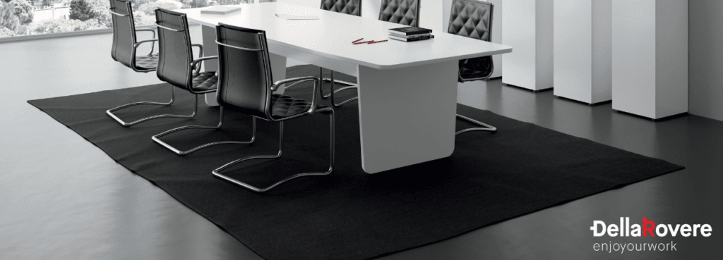 Modern Metrik Meeting Table with white top, black chairs, and black rug in a bright conference room.