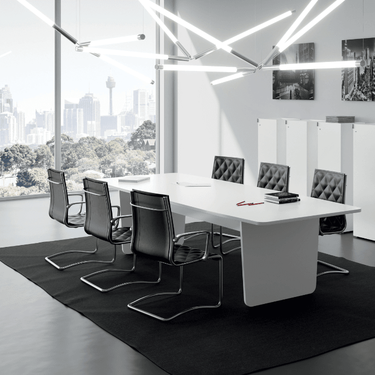Modern Metrik Meeting Table with black leather chairs in a bright, minimalist office.