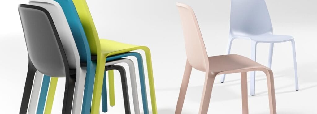 Stackable MONOis1 seminar chair in black, white, blue, and yellow. Pink and light blue chairs are separate.