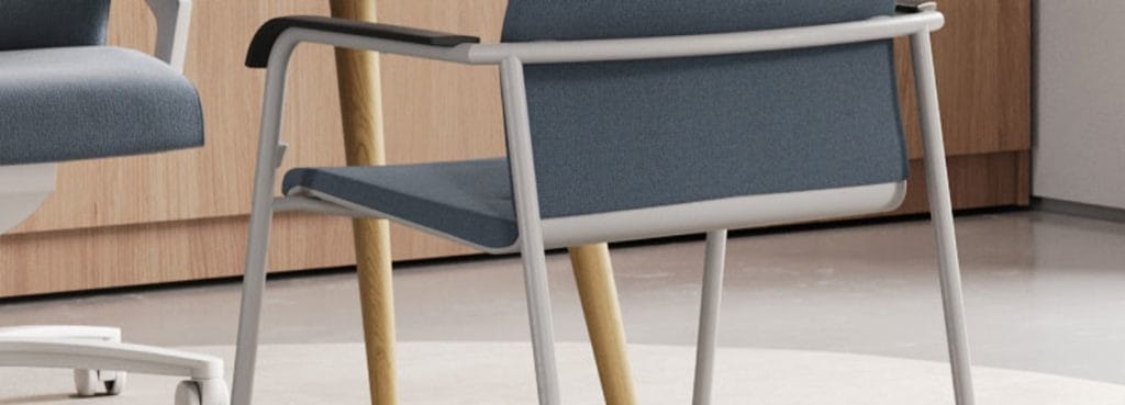 Modern ON visitor chair with blue fabric seat, light gray frame, and wooden legs.
