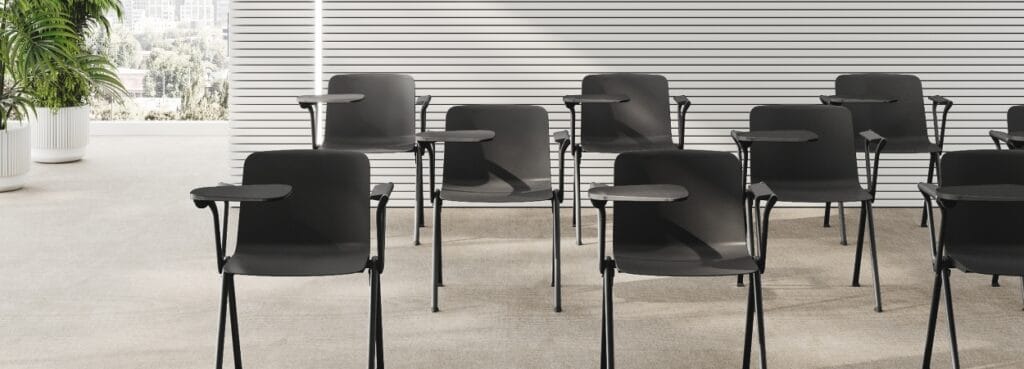 Modern black Fiction seminar chairs with writing tablet arms.