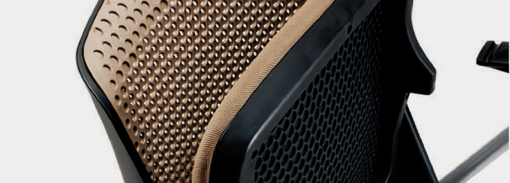 Close-up of Mobby chair's perforated, tan seat and black backrest. Mobile, stackable seating for seminars and classrooms.