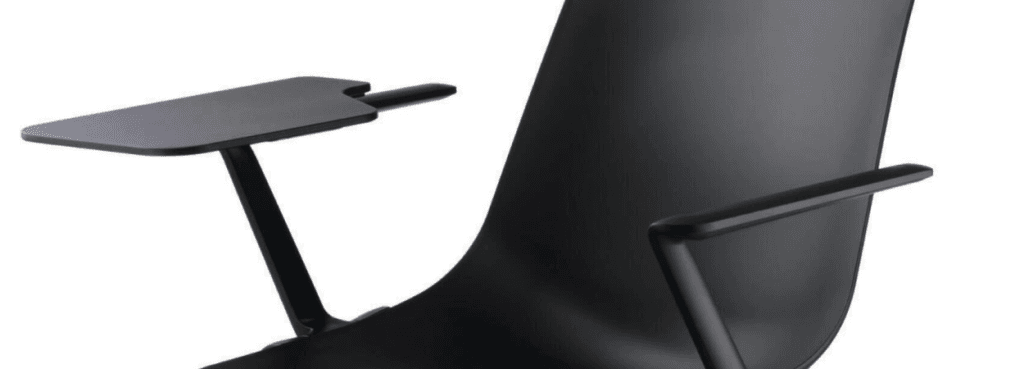 Close-up of a black Aula chair with armrests and a writing tablet.