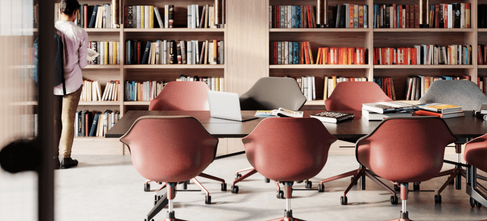 Conference room featuring Yonda chairs in red and gray, with a bookshelf backdrop.