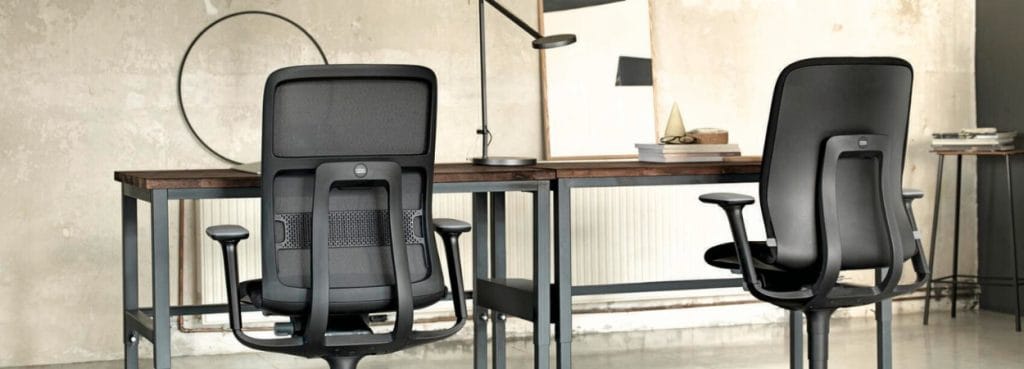 Wilkhahn AT office chairs in black, seen from behind, with desks.