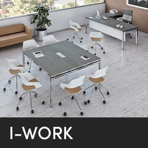 I-WORK studio office. Conference table with rolling chairs, desk, and couch in a modern office space.