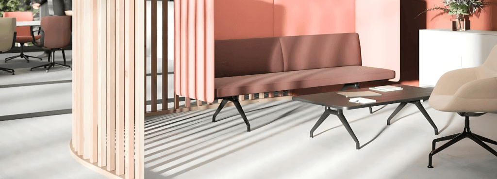 Modern Insit & Insit Screen Modular Seating System. Pink sofa, wooden screen, and black table create a stylish welcome area.