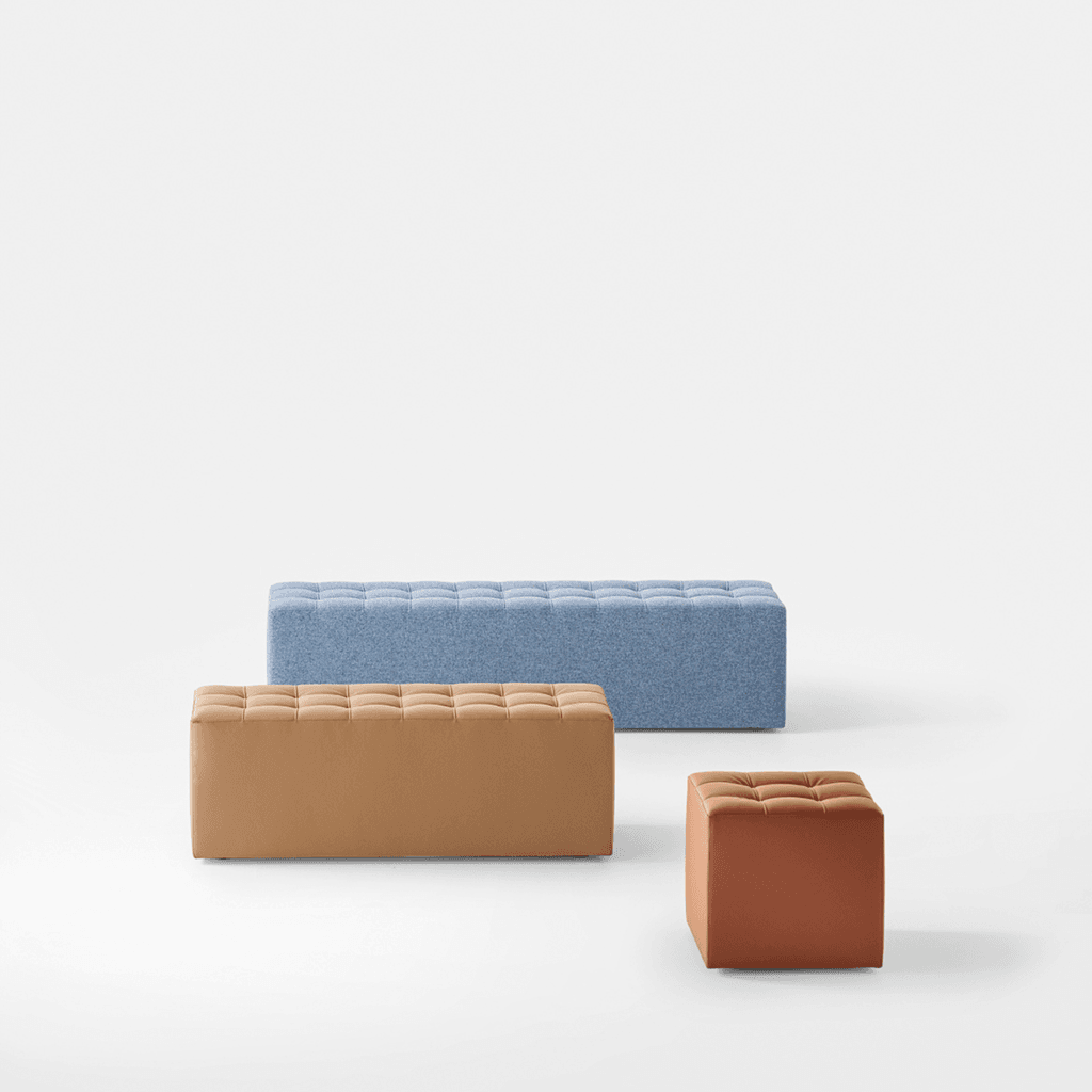 Kubox modular seating: Blue, tan, and brown upholstered benches and cube on white.