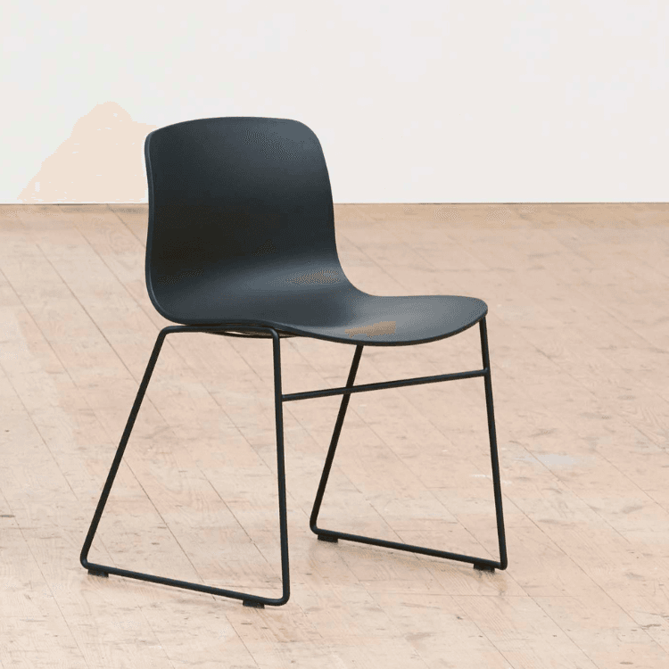 Side view of HAY AAC 08 chair in dark gray with a sleek, minimalist steel frame. Modern seating.