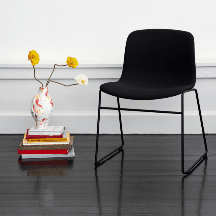 AAC 09 chair by HAY. Black, fully upholstered seat with a sleek steel frame. Modern design for stylish waiting areas.