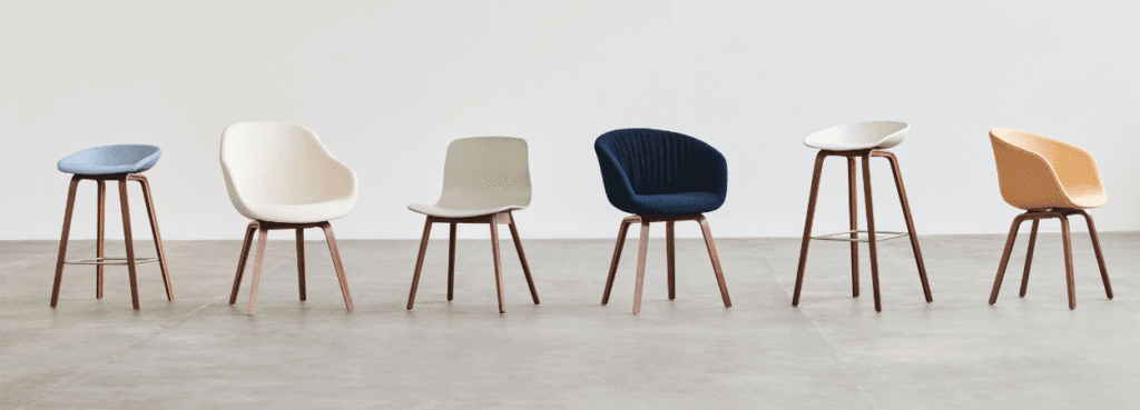 HAY AAC 12 chair series in various colors and styles with wood base. Modern seating for corporate and home spaces.
