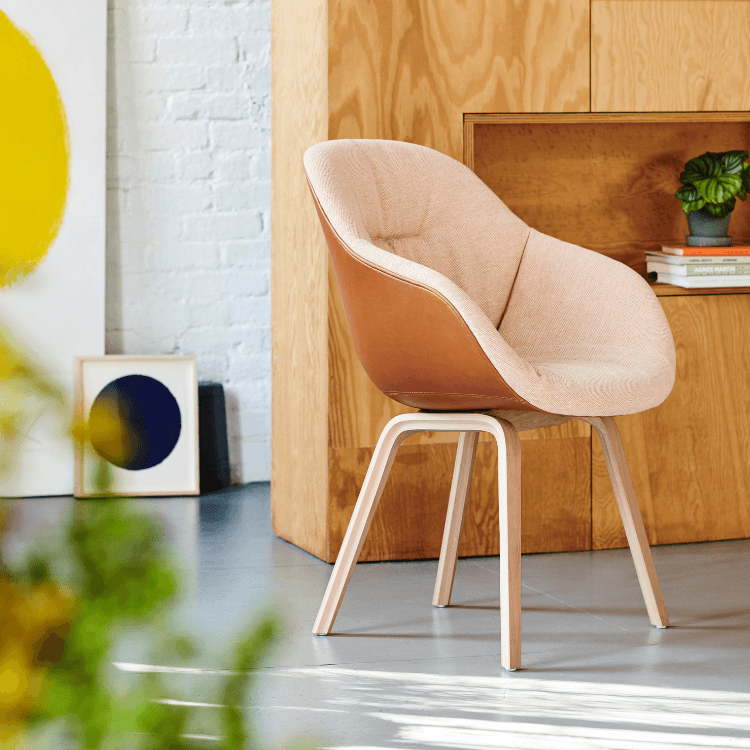 HAY AAC 123 Soft Duo chair. Quilted beige fabric, brown leather shell, and light oak legs. Modern design.