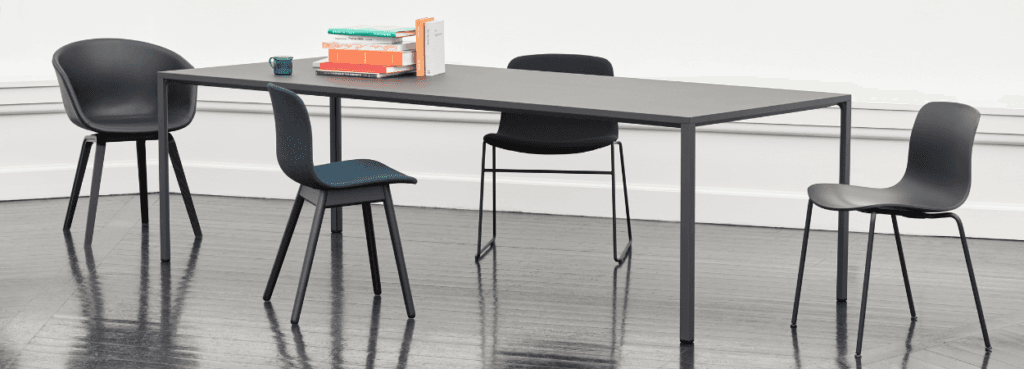 HAY AAC 16 chair in gray. Minimalist design with recycled plastic shell, metal legs. Modern seating.