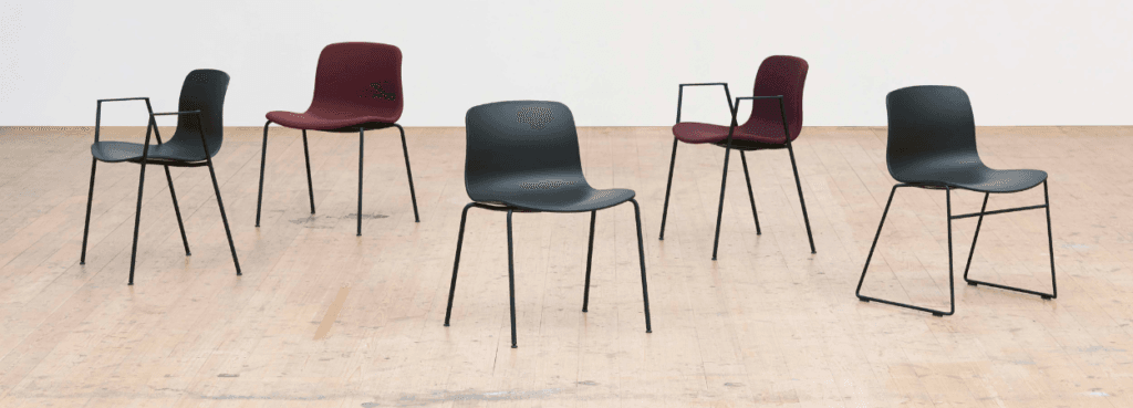HAY AAC 17 visitor chairs in black and burgundy with slim, stackable black legs.