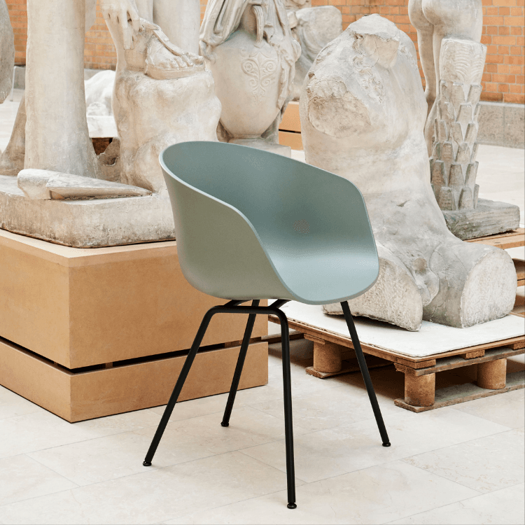 HAY AAC 26 chair in sage green with black steel base. Modern design.