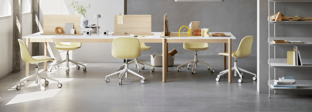 Muuto office furniture in Cyprus: Tables and chairs in a modern office setting.