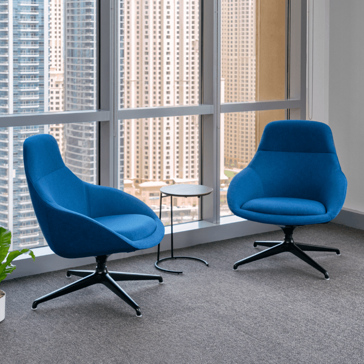 Two blue Always Lounge Chairs with black swivel bases. Modern office furniture.