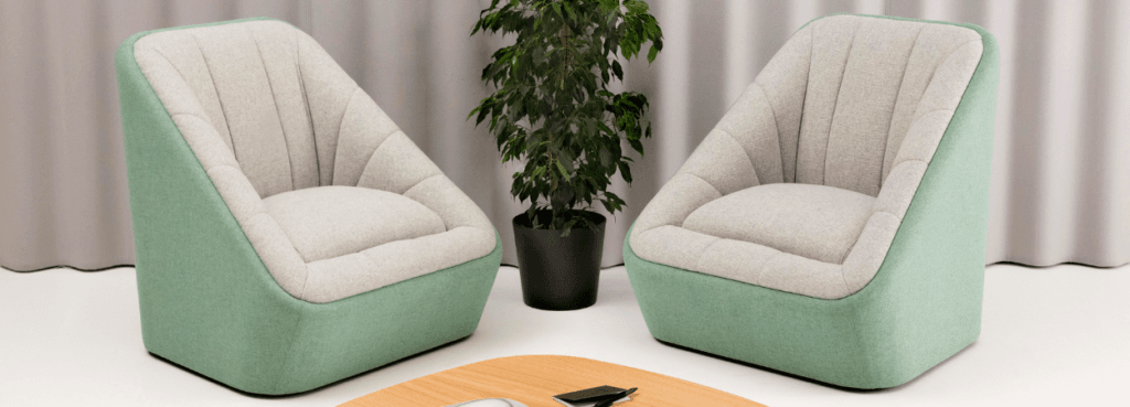 Two Fiji Chairs in light green and grey upholstery, paired with a modern wood table.