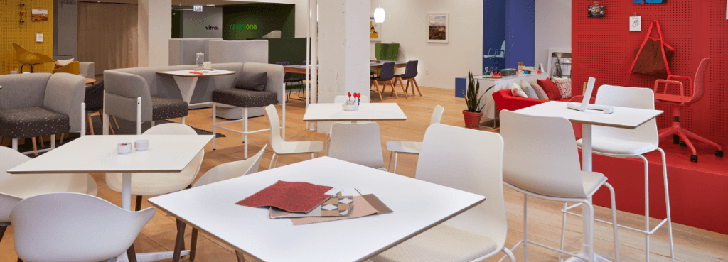 Bright, open office space with NaughtOne Polly Stool seating around tables. Modern design.