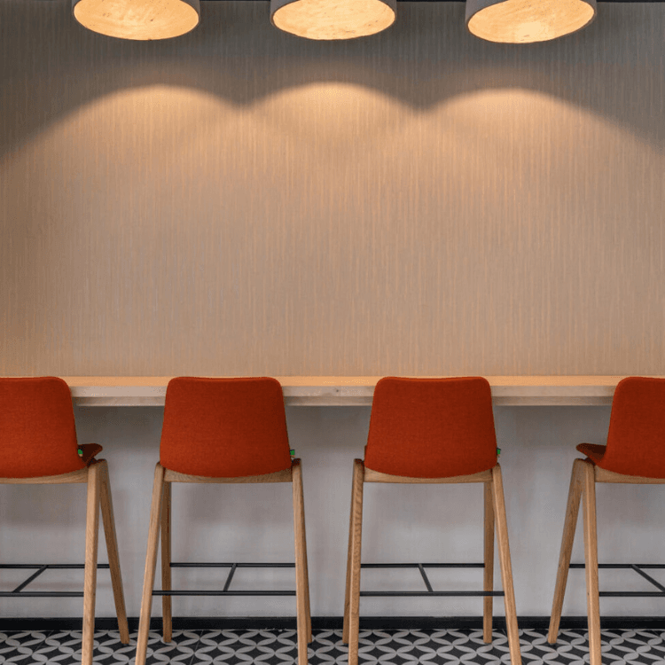 Four Ruby Wood Stools in orange fabric with oak legs, modern design.