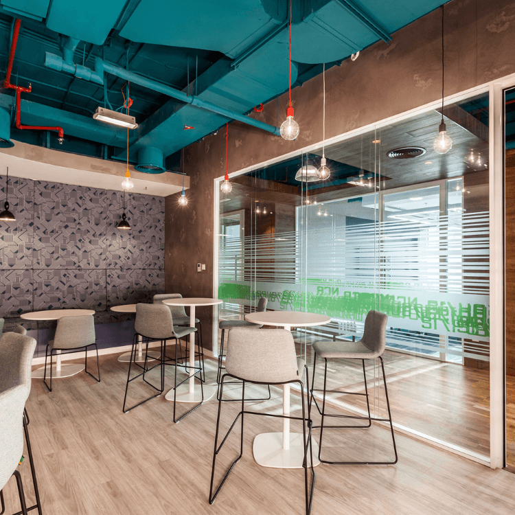 Modern office space featuring gray Viv Stool seating at white tables.