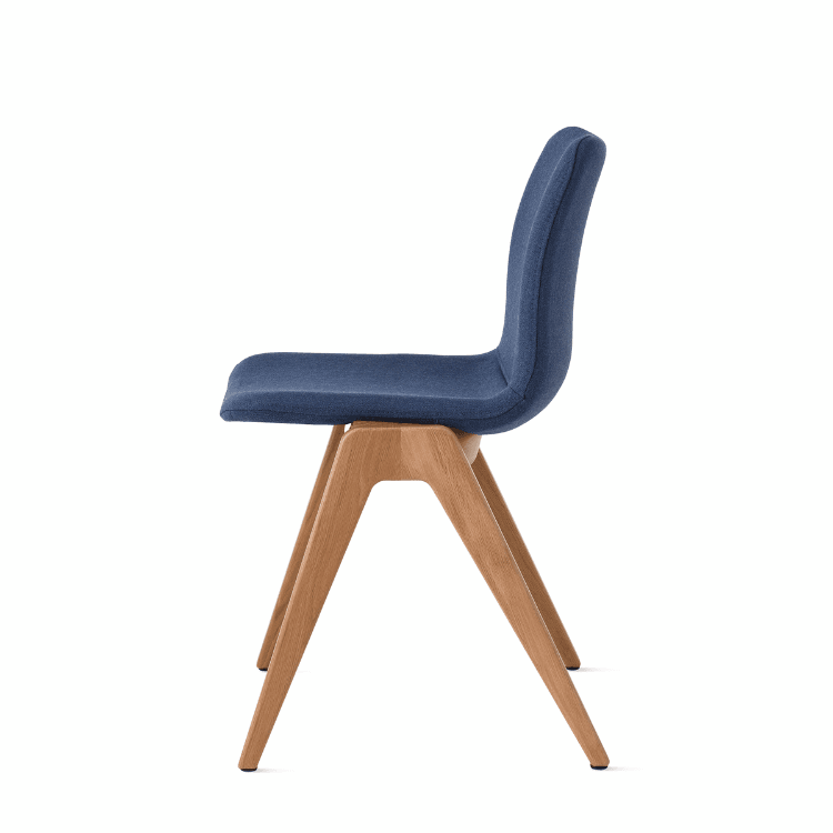Side view of a blue Viv Wood Chair with a light wood base.