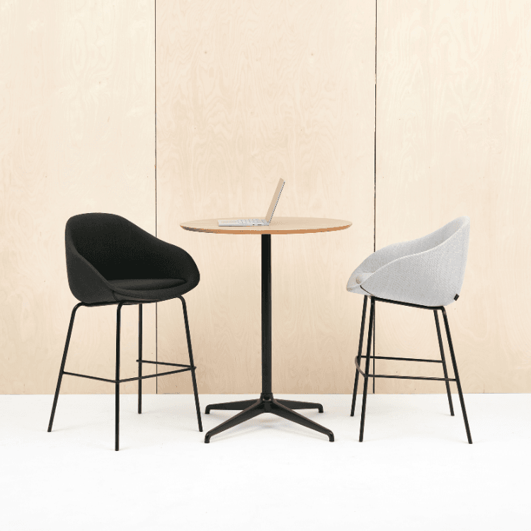 NaughtOne Always Stool: Black and gray fabric stools with a wooden table and laptop. Modern design for versatile seating.