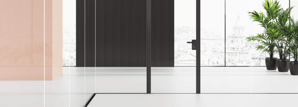 Mood MN glass partition wall featuring a central door with a black handle against a soft pink and ribbed dark backdrop.