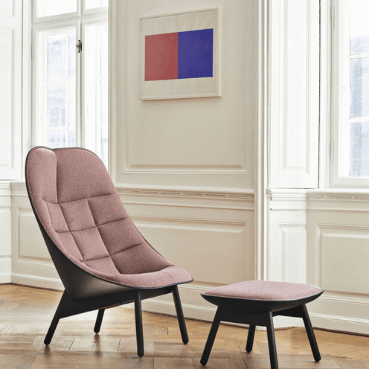 Uchiwa Quilted armchair in dusty pink with a black base and matching ottoman in a bright room.