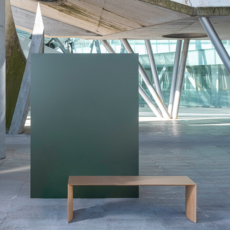 Museum bench by Infiniti in a public interior.