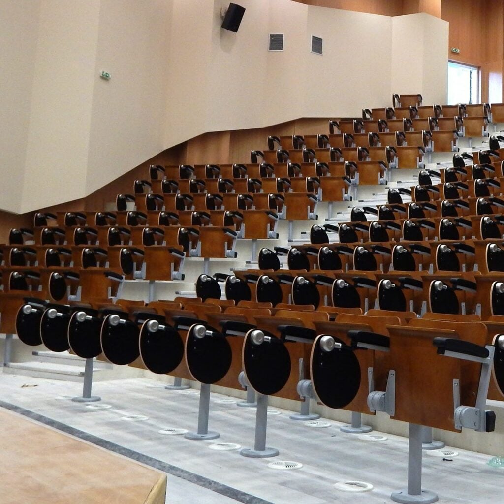 Aegean wood tip-up seats in a tiered auditorium