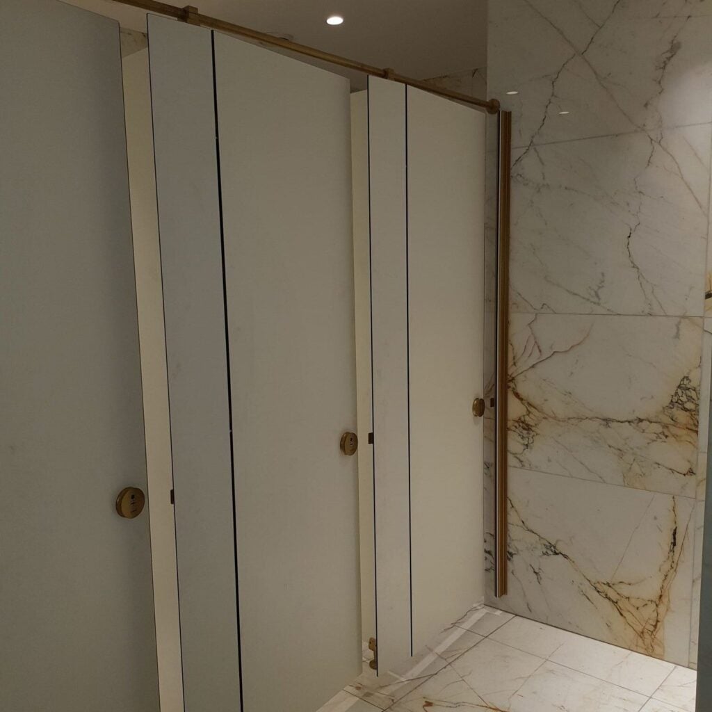 Arena HPL cubicles in a marble washroom