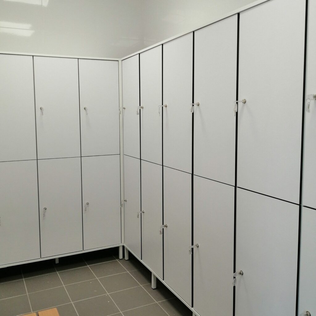 Two-tier compact laminate lockers on metal legs beside a bench