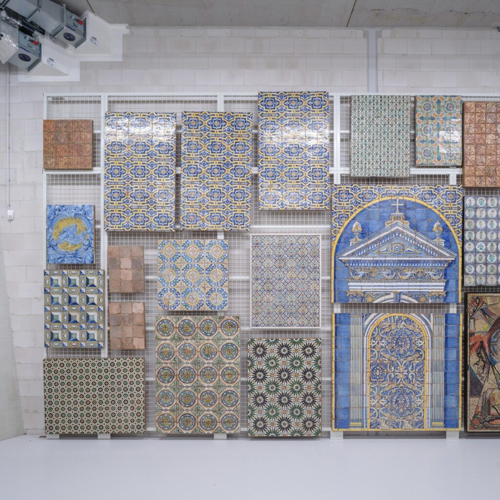 Wall-mounted mesh rack holding ceramic tile panels