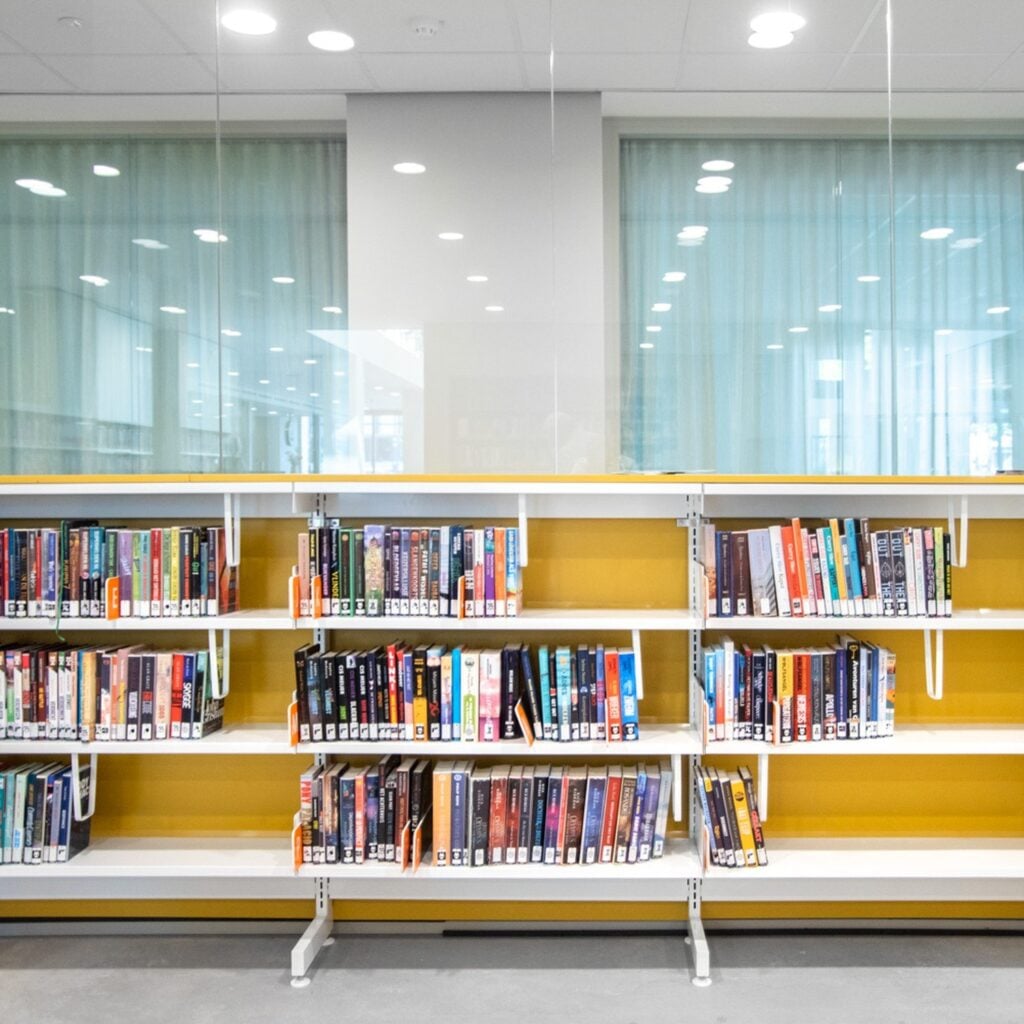 Low steel library shelving with yellow back panels