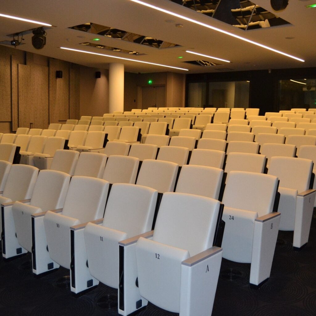 White Tempo seats in a wood-clad auditorium